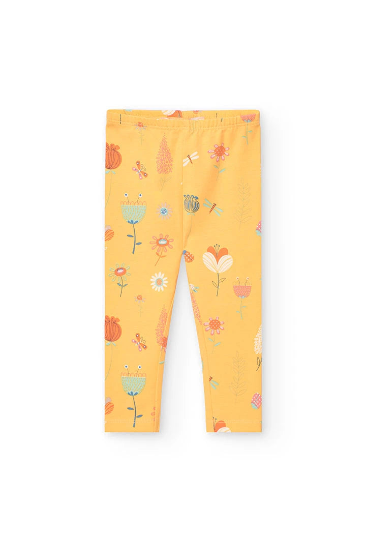 Leggings amarillos con patrón de flores y mariposas en tonos pastel, vista frontal.