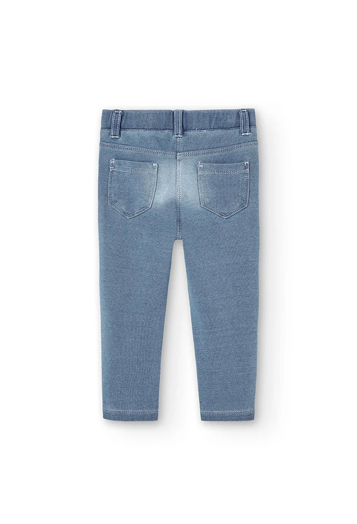 Vista trasera completa de leggings tipo jeans azul claro para niña.