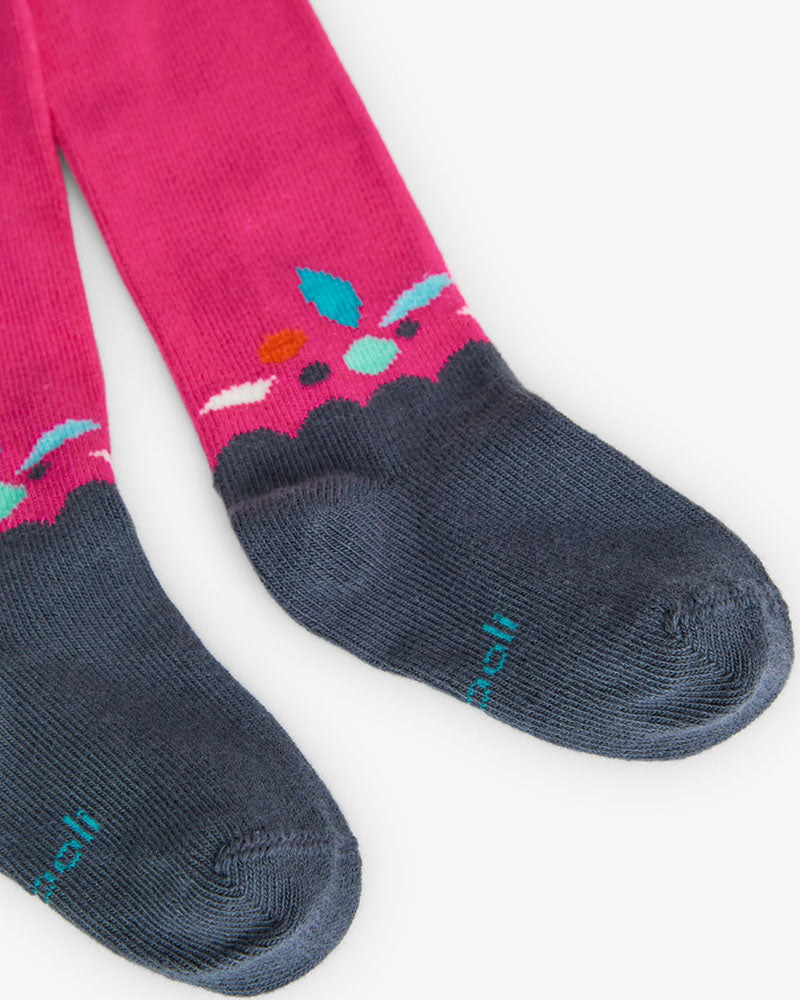 Mallas rosas de niña con puntera azul marino y detalle de hojas de colores en el tobillo.