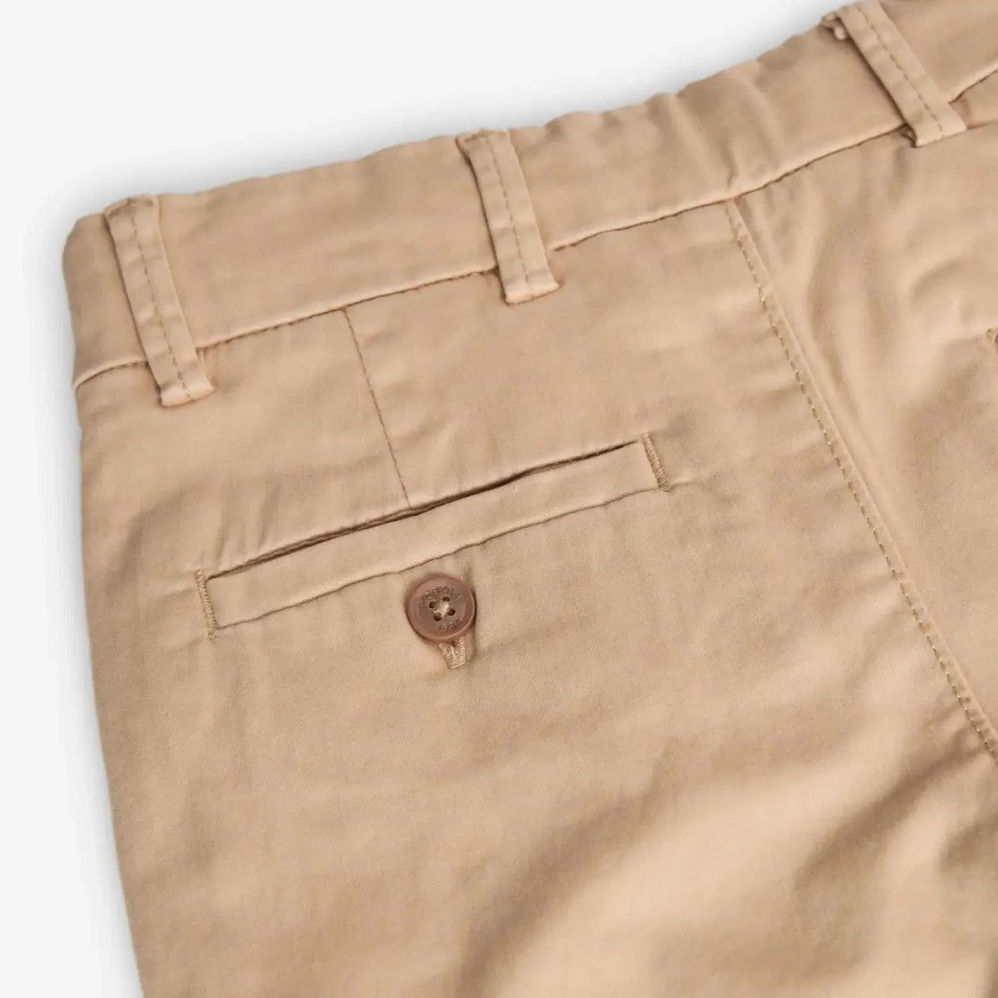 Detalle del bolsillo trasero del pantalón beige Boboli de Cachaboo, con botón decorativo y costuras reforzadas para un acabado elegante.