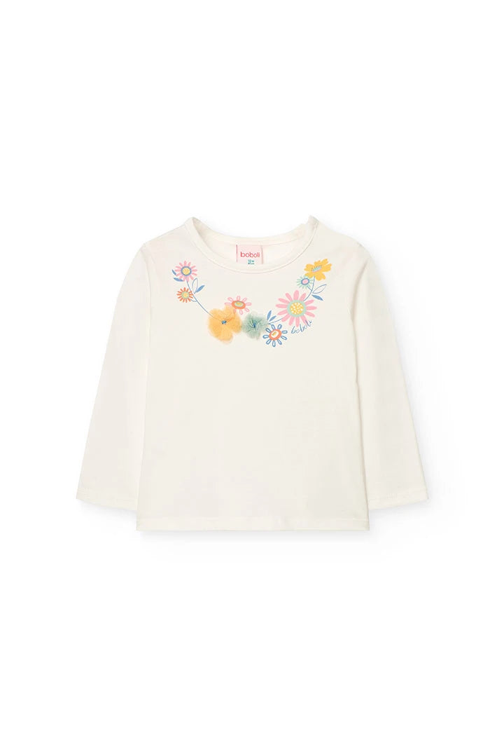 Playera blanca de manga larga con bordados de flores coloridas y detalles en relieve.