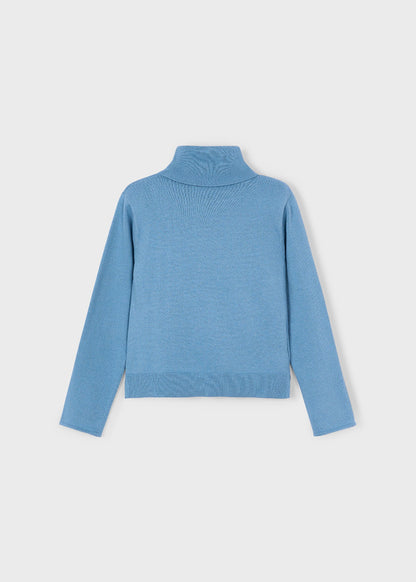 Vista trasera del suéter de punto fino color azul cielo con cuello alto para niña.