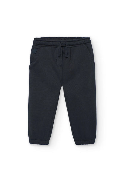 Vista frontal de un pantalón jogger de felpa color carbón para niña, con cintura elástica y cordón.

