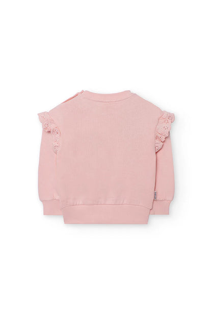 Vista trasera de la sudadera rosa para niña, mostrando los olanes en los hombros y los botones de presión.